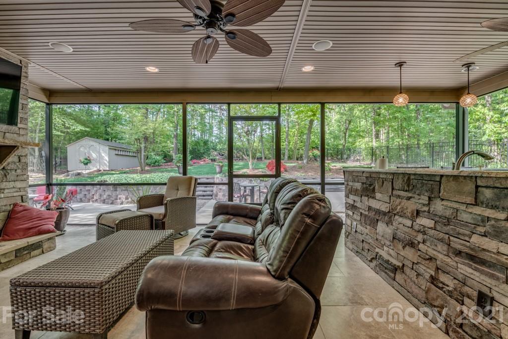 4367 Lake Shore Road North Denver, NC 28037 - Photo 37 of 48 a living room with furniture and a floor to ceiling window