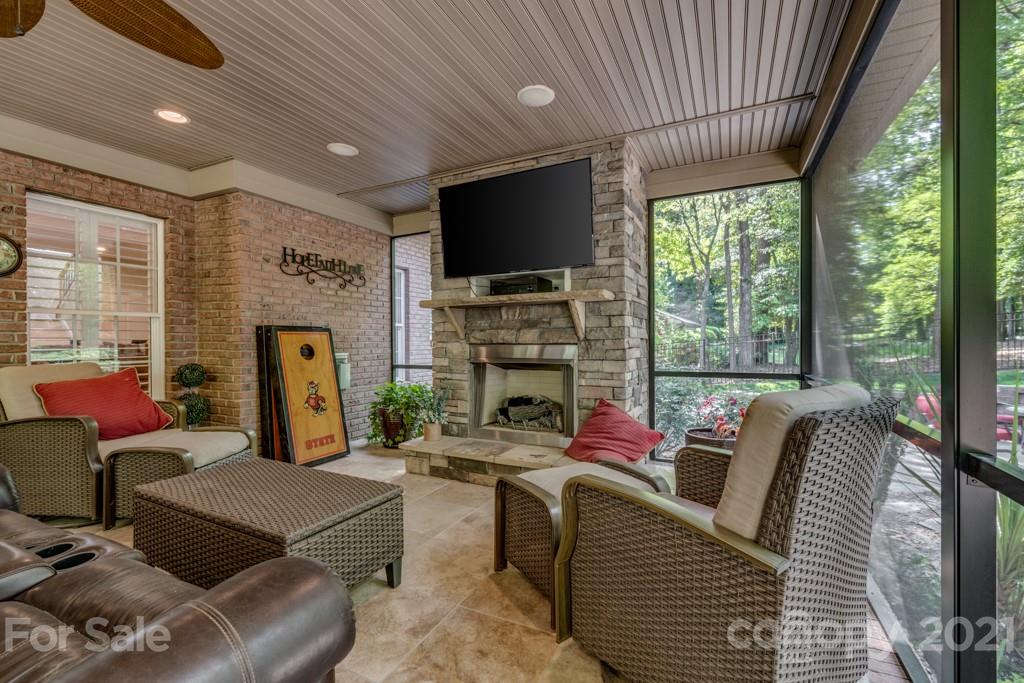 4367 Lake Shore Road North Denver, NC 28037 - Photo 39 of 48 a living room with furniture a flat screen tv and a fireplace