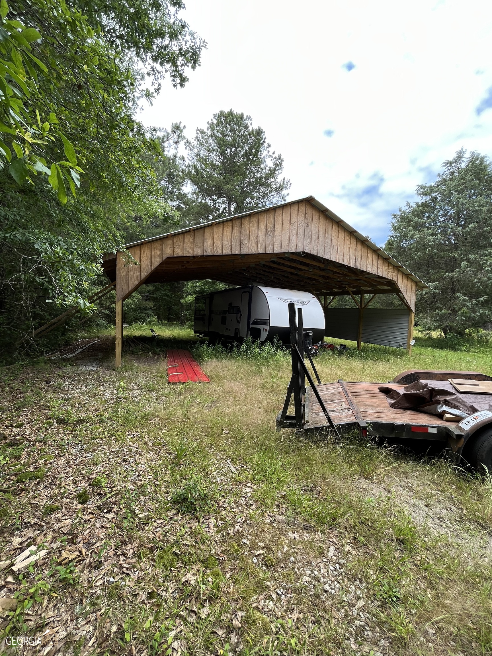 80 Allen Spur Road Grantville, GA 30220 - Photo 1 of 1 a backyard of a house with barbeque oven and table