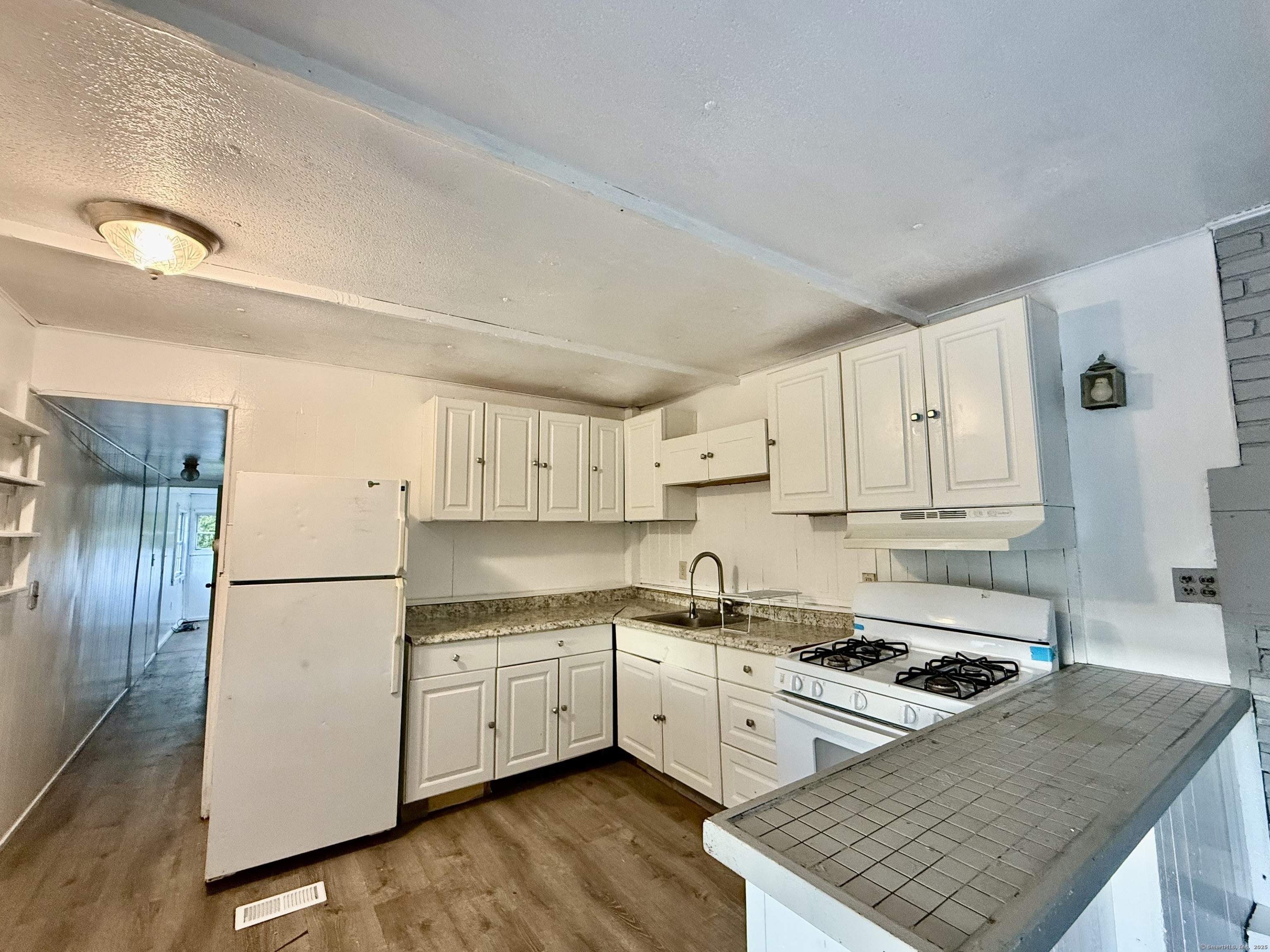 243 Champion Road Franklin, CT 06254 - Photo 6 of 13 a kitchen with a white stove top oven and refrigerator