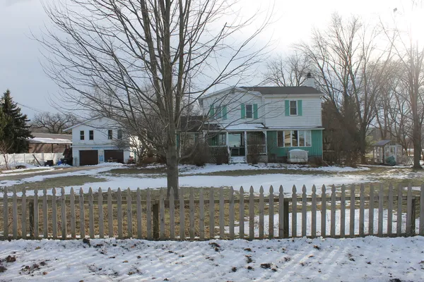 a front view of a house with a garden