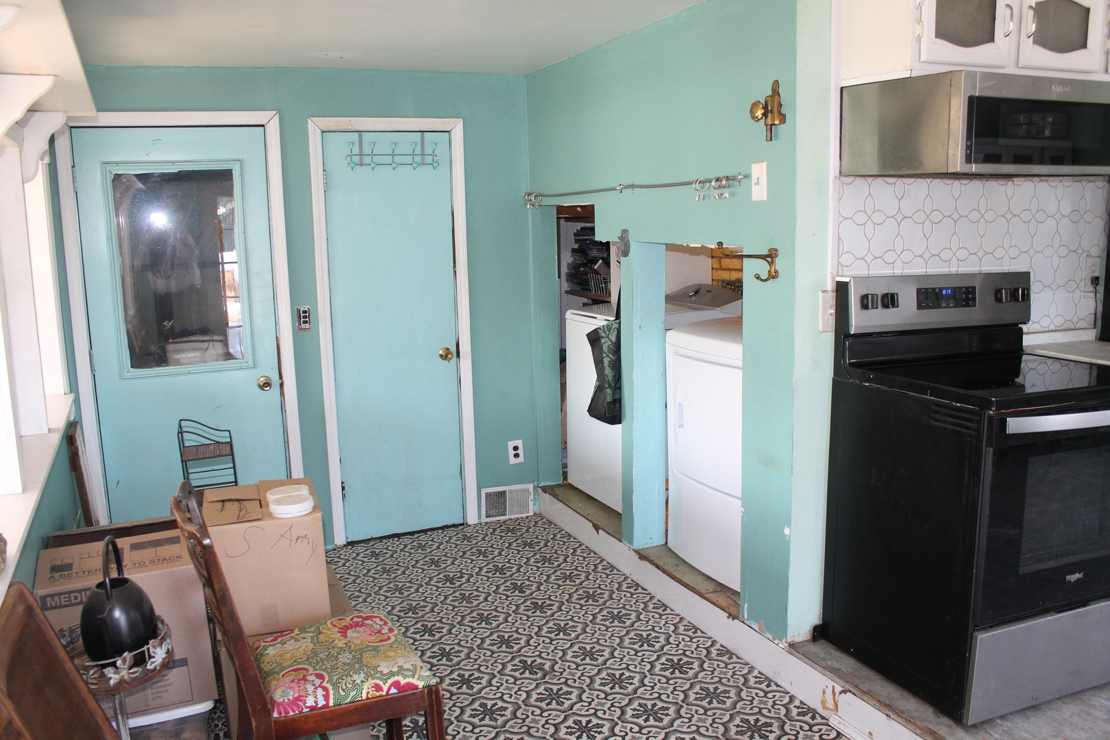 16038 Quigley Road Sycamore, IL 60178 - Photo 25 of 42 a living room with a couch and a stove next to a window