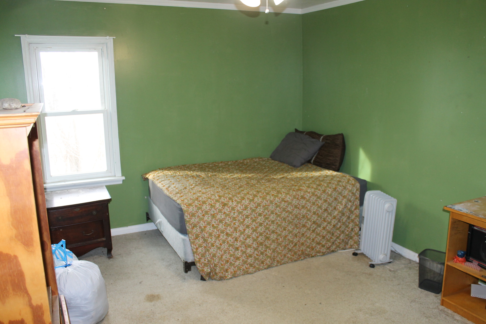16038 Quigley Road Sycamore, IL 60178 - Photo 28 of 42 a bed sitting in a bedroom next to a window