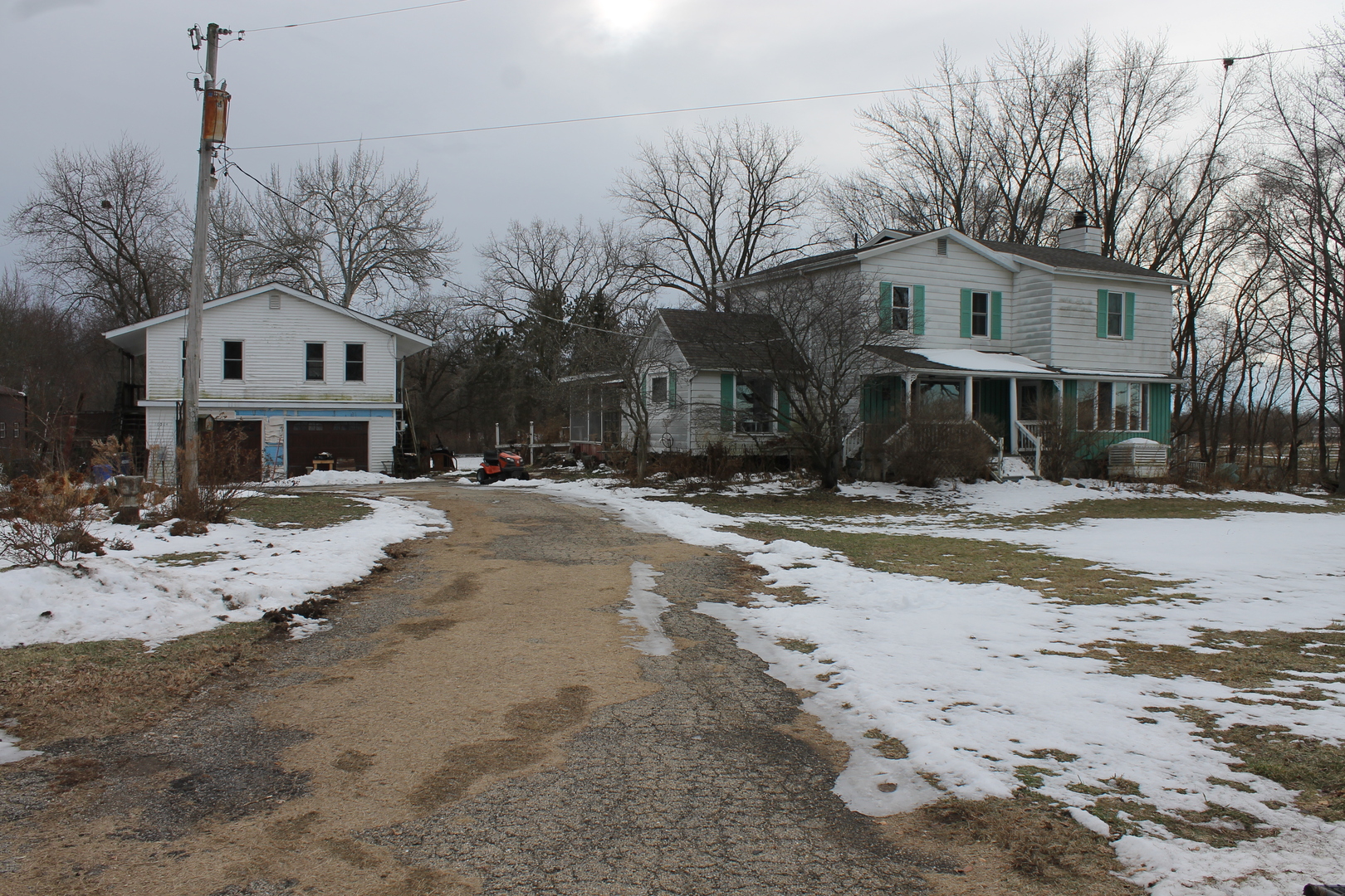 16038 Quigley Road Sycamore, IL 60178 - Photo 3 of 42 a front view of a house with a yard covered with snow
