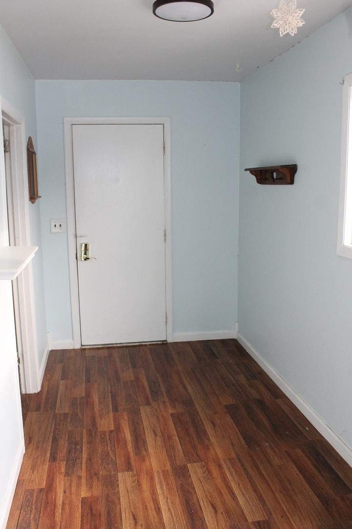 16038 Quigley Road Sycamore, IL 60178 - Photo 42 of 42 a view of a room with wooden floor and a window