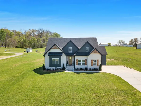 a front view of a house with a big yard