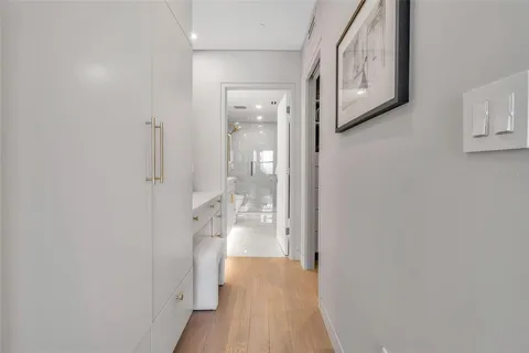 a bedroom with a bed and a lamp on dresser