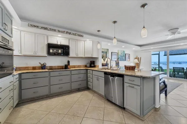 a kitchen with a sink window and cabinets