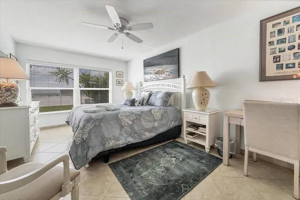 a bedroom with a bed a table and chair