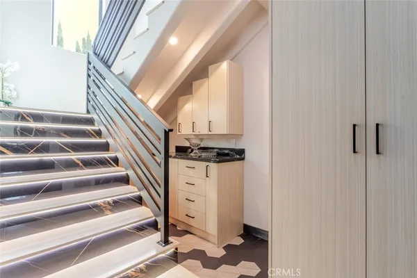 a view of entryway and hall with wooden floor