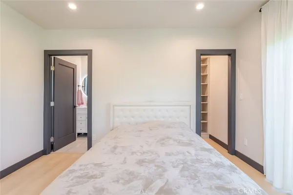 a bedroom with a bed and a mirror