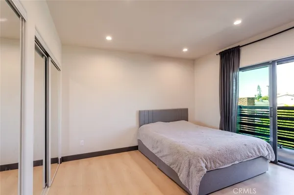 a bedroom with a bed and a large window