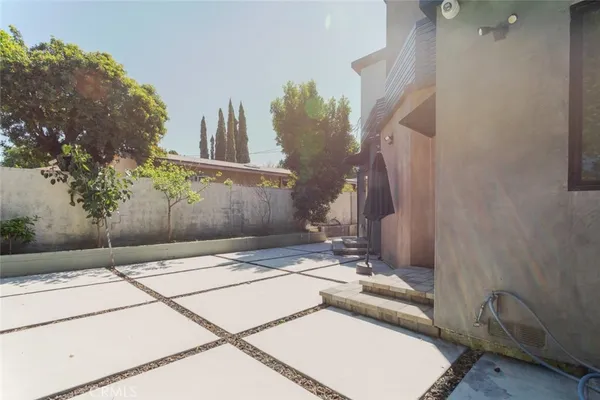 an aerial view of a house with a yard and seating area