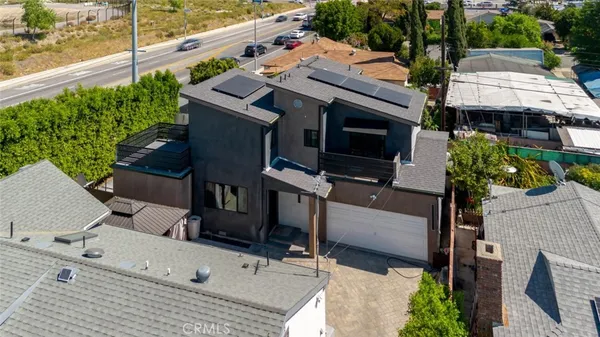 an aerial view of a house with lake view and a garden