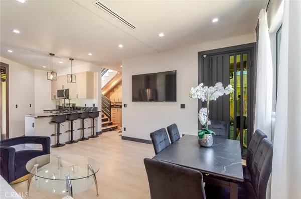 a dining room with furniture and wooden floor