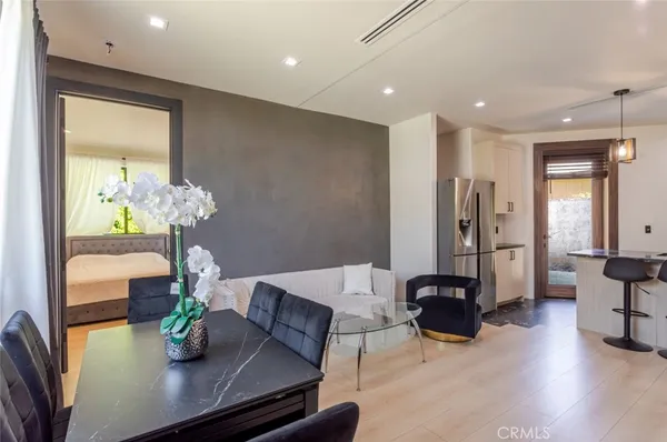 a living room with furniture and chandelier
