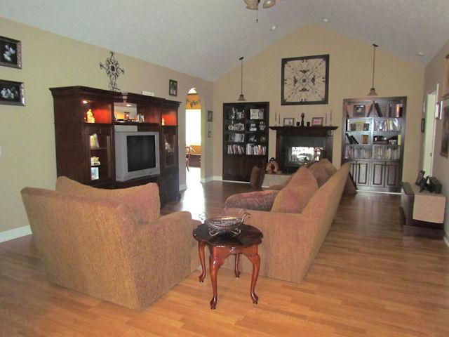 1417 Peyton Road Lebanon, TN 37087 - Photo 3 of 20 This beautiful living room has hardwood flooring, a ceiling fan, built in book shelves and a wood burning fireplace.