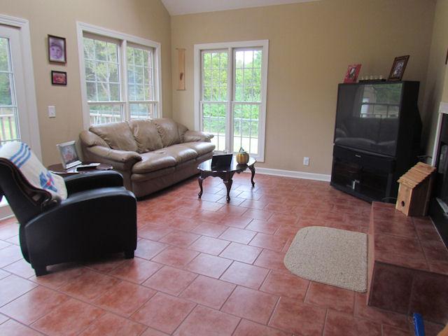 1417 Peyton Road Lebanon, TN 37087 - Photo 8 of 20 This peaceful Florida room has tile flooring, a wood burning fireplace and an exterior door to the back deck. There is also a sky light.