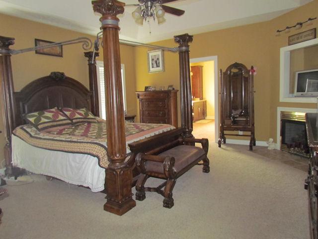 1417 Peyton Road Lebanon, TN 37087 - Photo 9 of 20 Here is the incredible master bedroom which has carpet, a ceiling fan, a fireplace, a cubby for your TV and a tray ceiling.