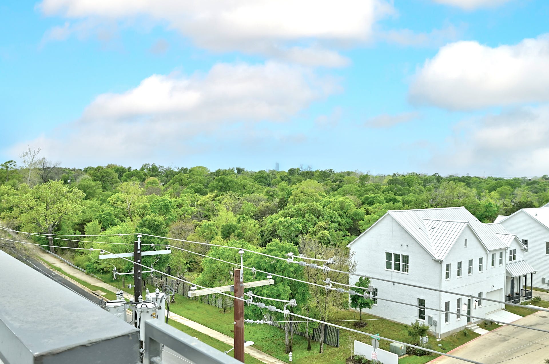 4801 Springdale Road, Unit 1301 Austin, TX 78723 - Photo 37 of 39 Perched above a verdant tree line, this contemporary residence offers serene views.