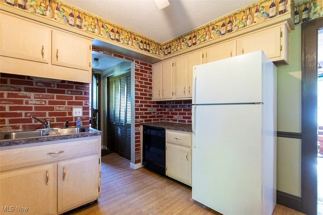 3555 Marks Road Medina, OH 44256 - Photo 6 of 19 Kitchen featuring dishwasher, sink, light hardwood / wood-style floors, white fridge, and brick wall