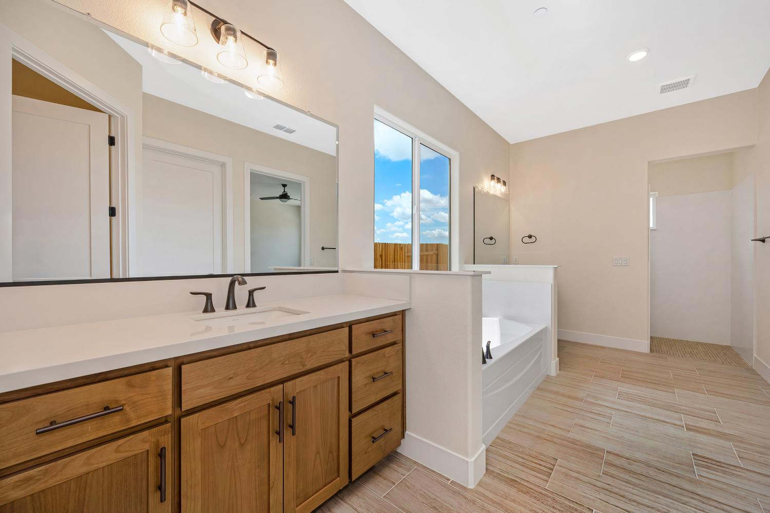 3922 Buxus Road Rocklin, CA 95765 - Photo 8 of 11 a bathroom with a granite countertop double vanity sink and mirror