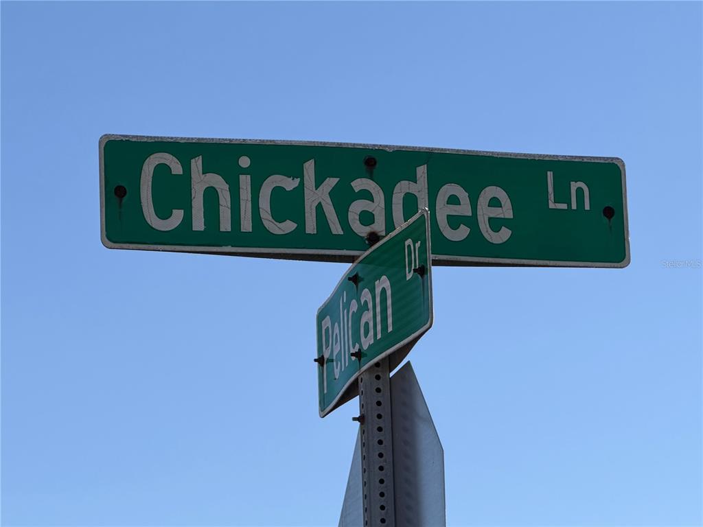 7 Chickadee Lane Placida, FL 33946 - Photo 4 of 13 a close up of a street sign