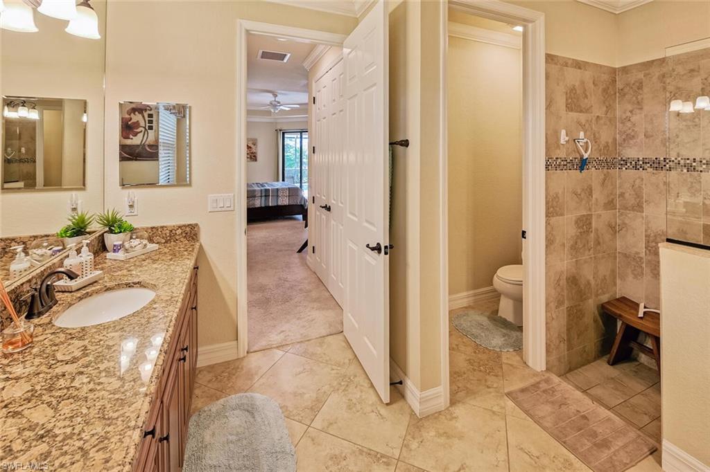 9415 Piacere Way Naples, FL 34113 - Photo 15 of 35 a spacious bathroom with a sink and a mirror