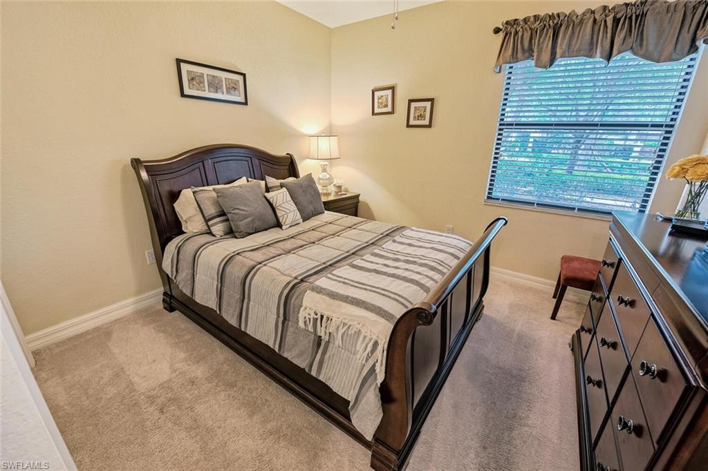 9415 Piacere Way Naples, FL 34113 - Photo 16 of 35 a bedroom with bed and a window