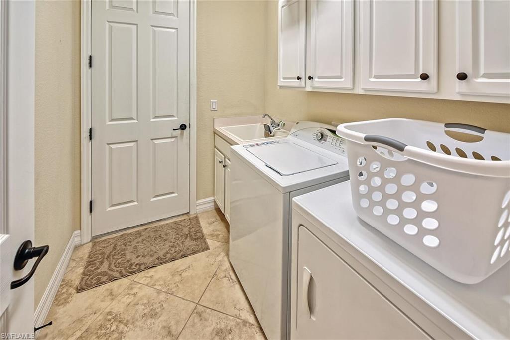 9415 Piacere Way Naples, FL 34113 - Photo 18 of 35 a utility room with dryer and washer