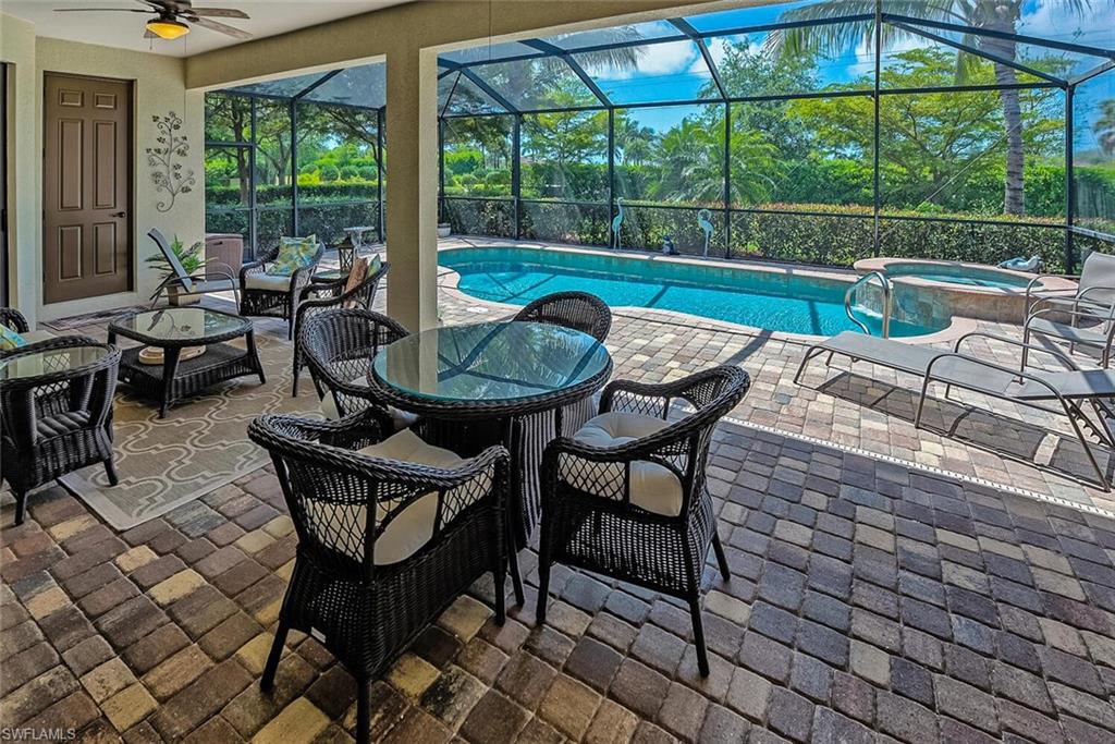 9415 Piacere Way Naples, FL 34113 - Photo 19 of 35 a view of a patio with a dining table and chairs