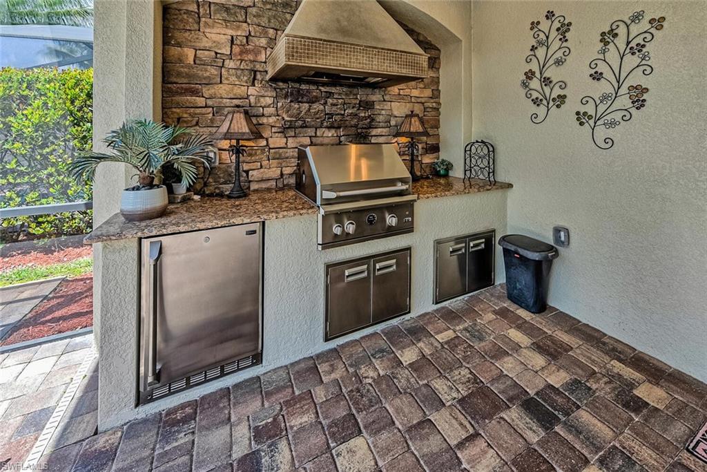 9415 Piacere Way Naples, FL 34113 - Photo 21 of 35 a kitchen with a stove and a microwave