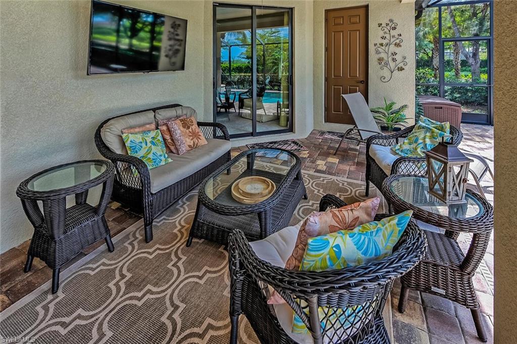 9415 Piacere Way Naples, FL 34113 - Photo 23 of 35 a view of a chairs and table in patio