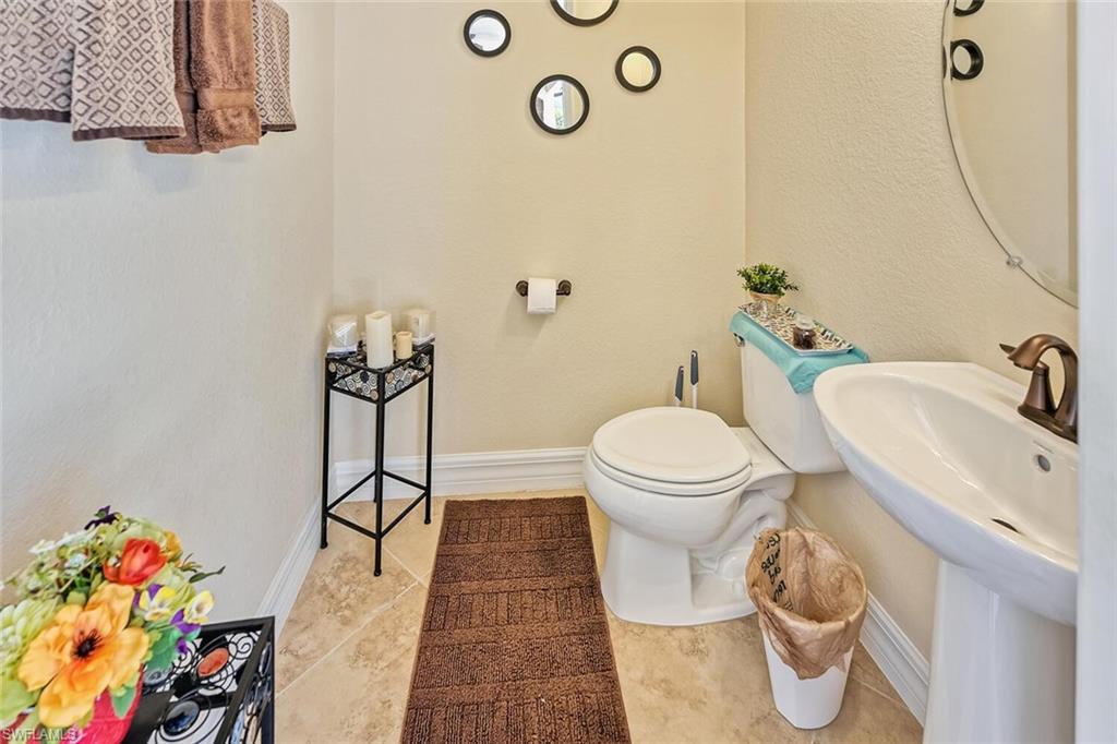 9415 Piacere Way Naples, FL 34113 - Photo 24 of 35 a bathroom with a toilet and a sink