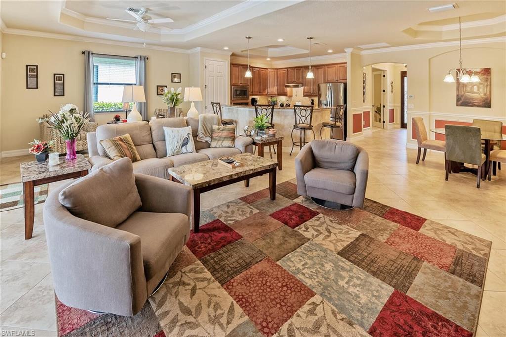 9415 Piacere Way Naples, FL 34113 - Photo 4 of 35 a living room with furniture and wooden floor