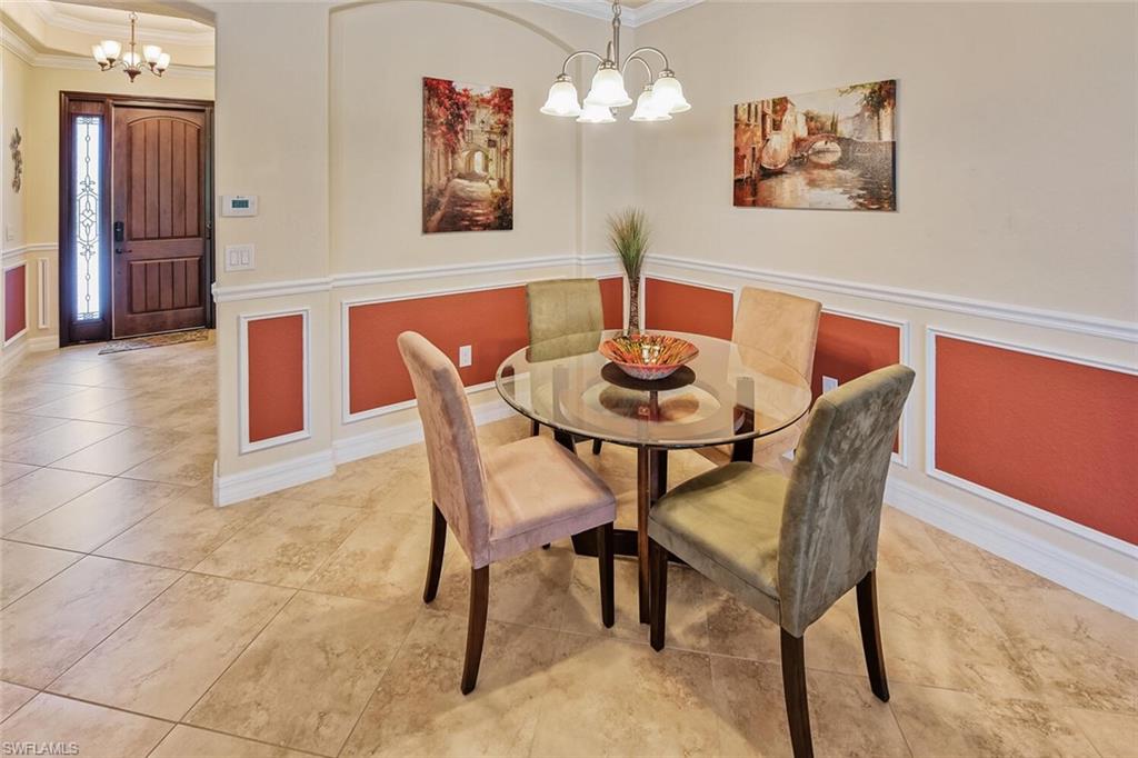 9415 Piacere Way Naples, FL 34113 - Photo 7 of 35 a dining room with furniture and wooden floor