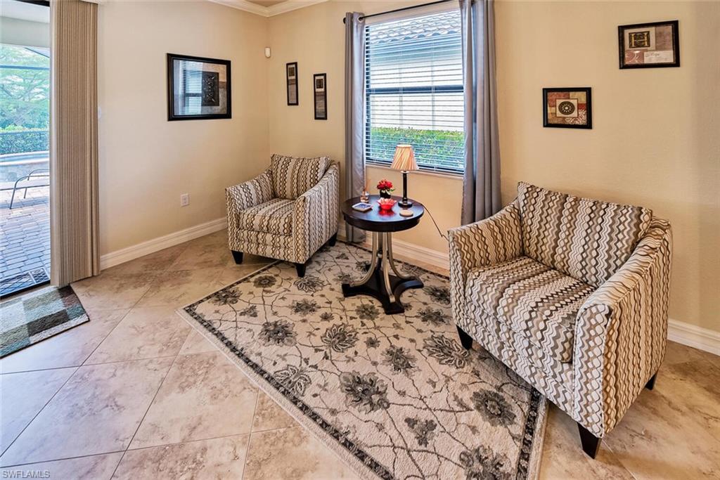9415 Piacere Way Naples, FL 34113 - Photo 8 of 35 a living room with a couch and a table