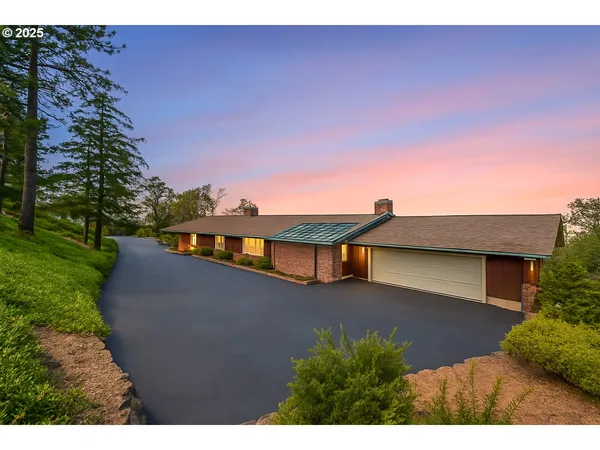a view of a house with a yard and a large window