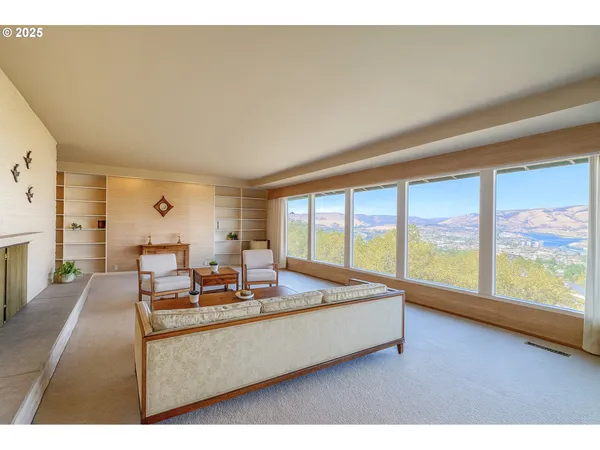 a living room with furniture and large windows