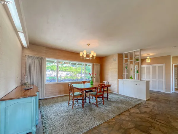 a view of a dining room with furniture window and outside view