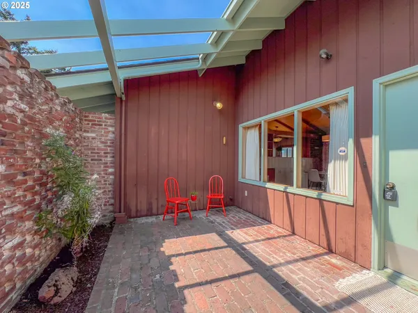 a view of balcony with two chairs and a table