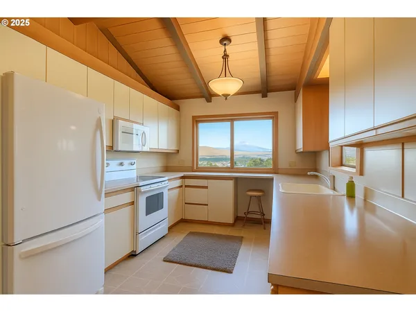 a kitchen with a refrigerator and a sink