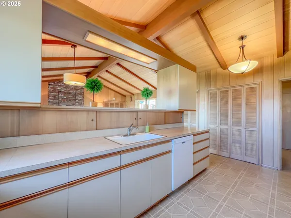 a bathroom with a sink a vanity and a large mirror