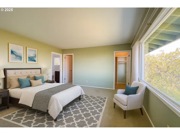 a bedroom with a bed and a large window