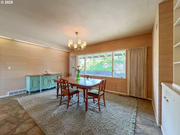 a dining room with furniture a rug and a chandelier