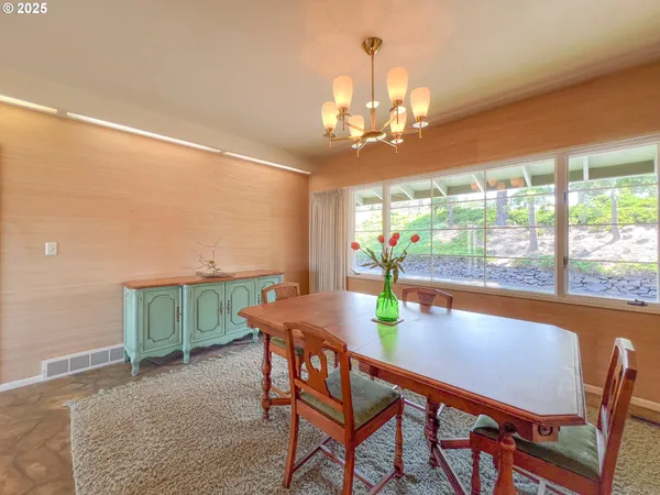 a view of a dining room with furniture window and outside view
