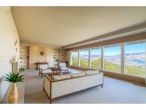 a living room with furniture and large windows