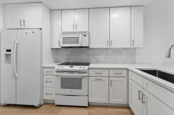 a kitchen with sink cabinets and wooden floor