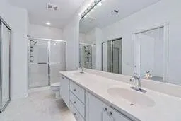 a spacious bathroom with a granite countertop sink and a mirror