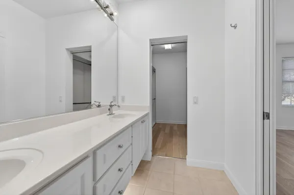 a spacious bathroom with a shower sink vanity mirror and toilet